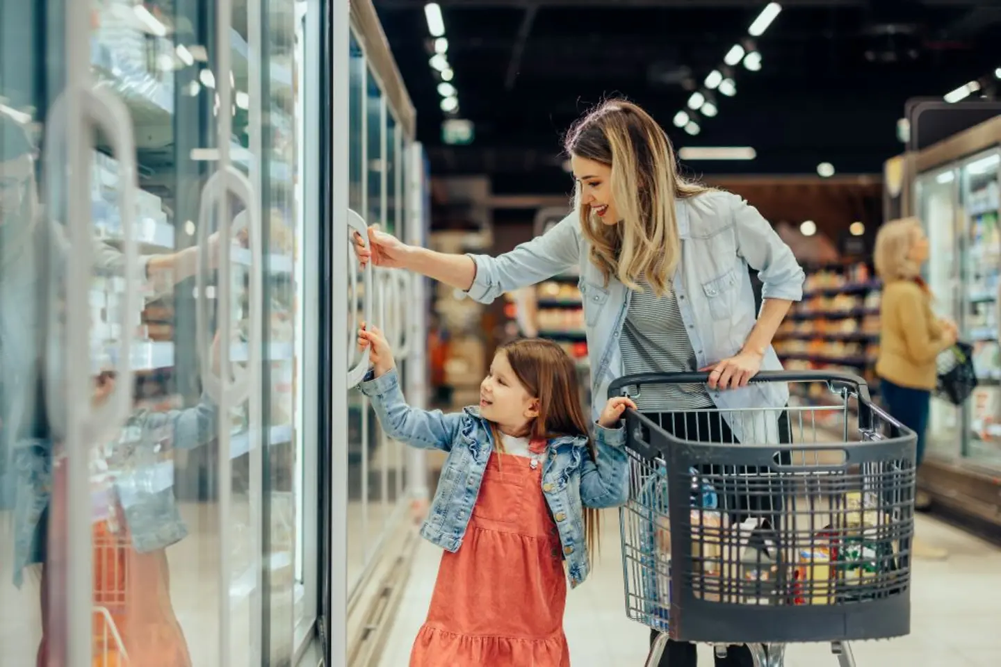 Woman with child shopping in grocery store