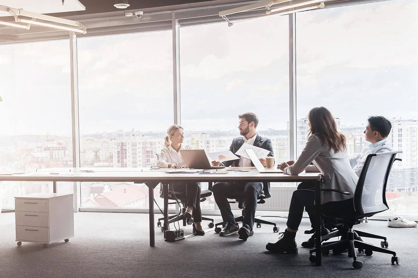 Business people work on a project in a modern office with a panoramic view
