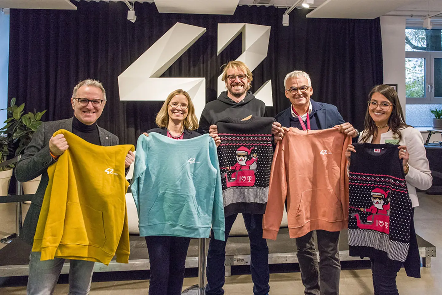 Colleagues with their 42 hoodies 