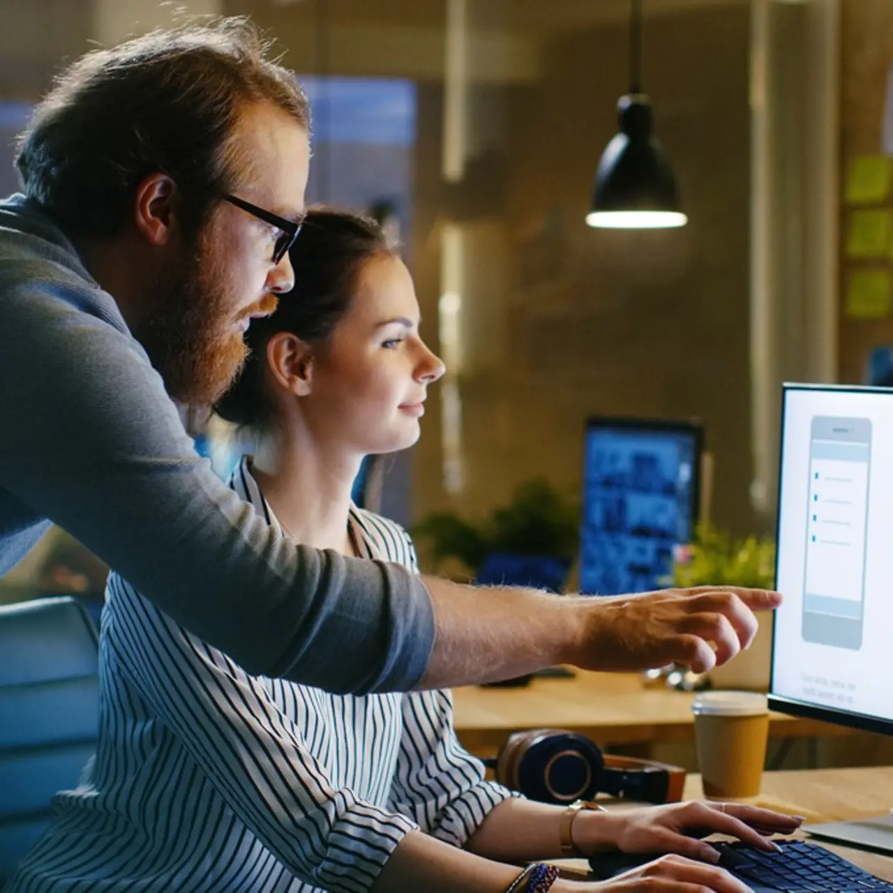 Two people in front of the screen